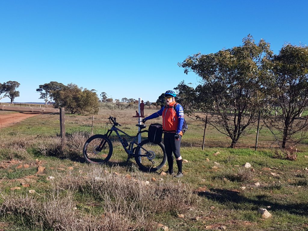 Blue next to the Gustav and his dog marker outside the childhood home of Colin Thiele